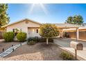 Tan house with landscaped yard, walkway, and mailbox at 907 E 9Th Ave, Mesa, AZ 85204