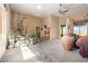 Spacious living room with tile floors, a rock garden feature, and large windows at 1904 E Venado Dr, New River, AZ 85087