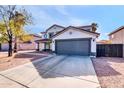 Two-story house with gray garage door and desert landscaping at 10847 E Forge Cir, Mesa, AZ 85208