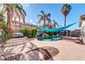 Relaxing backyard oasis with pool, spa, and shade sail at 10847 E Forge Cir, Mesa, AZ 85208