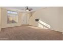 Spacious living room with neutral carpeting and high ceilings at 6321 S Teresa Dr, Chandler, AZ 85249