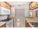 Kitchen with wood cabinets and white appliances at 540 N May St # 1109, Mesa, AZ 85201