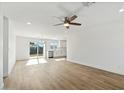 Bright and airy living room with vinyl flooring and ceiling fan at 3121 W Libby St, Phoenix, AZ 85053