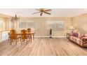 Living and dining area with wood-look floors and a striped sofa at 5546 E Player Pl, Mesa, AZ 85215