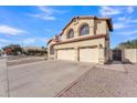 Two-story house with a three-car garage and desert landscaping at 2120 N 125Th Ave, Avondale, AZ 85392