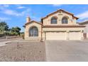 Two-story house with a three-car garage and desert landscaping at 2120 N 125Th Ave, Avondale, AZ 85392