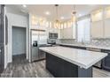 Modern kitchen with island, stainless steel appliances, and white cabinets at 7750 E Broadway Rd # 723, Mesa, AZ 85208