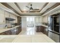 Spacious kitchen with dark wood cabinets and stainless steel appliances at 8530 E Pepper Tree Ln, Scottsdale, AZ 85250