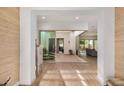 Open concept entryway with wood-look tile, courtyard access, and a view of the living room at 17197 W Thousand Oaks St, Surprise, AZ 85388