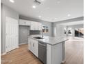 Modern kitchen with white cabinets, gray countertops, and island at 17840 W Encinas Ln, Goodyear, AZ 85338