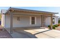 Grey single level home with carport at 3301 S Goldfield Rd # 1009, Apache Junction, AZ 85119