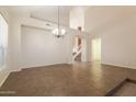 Spacious dining room with tile floors and a view of the staircase at 16847 S 13Th Way, Phoenix, AZ 85048
