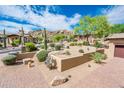 Landscaped front yard with desert plants and brick pavers leading to the home at 27440 N Alma School Pkwy # 33-1, Scottsdale, AZ 85262