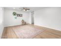 Bright and airy living room with light wood flooring and a ceiling fan at 332 W Palo Verde Dr, Superior, AZ 85173