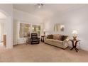 Living room features a large window, plush seating, and a relaxing atmosphere at 14321 W Robertson Dr, Sun City West, AZ 85375