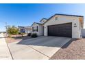 Single-story house with a two-car garage and desert landscaping at 36063 W San Alvarez Ave, Maricopa, AZ 85138