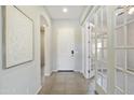 Bright and airy entryway with tiled floors and french doors at 10609 E Evergreen St, Mesa, AZ 85207