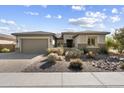 Modern single story home with gray garage door and stone accents at 10609 E Evergreen St, Mesa, AZ 85207