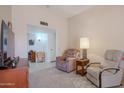 Relaxing living room with comfortable seating and a view to the dining area at 10845 W Hibiscus Dr, Sun City, AZ 85373