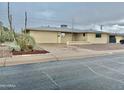 Tan single story home with attached garage and small front yard at 5522 E Colby St, Mesa, AZ 85205