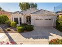 White single story home with a two car garage and desert landscaping at 11544 W Javelina Ct, Surprise, AZ 85378