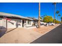 Exterior view showing the front of the house, driveway, and part of the street at 7950 E Keats Ave # 130, Mesa, AZ 85209