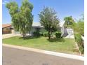 House exterior showcasing a well-maintained lawn and trees at 4936 E Coronado Rd, Phoenix, AZ 85008
