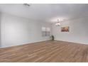 Spacious dining area with wood-look floors and neutral walls at 45680 W Barbara Ln, Maricopa, AZ 85139