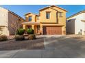 Two-story house with a brown door and attached garage at 45680 W Barbara Ln, Maricopa, AZ 85139