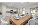 Modern kitchen with island, granite countertops, and stainless steel appliances at 36060 W San Ildefanso Ave, Maricopa, AZ 85138