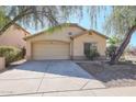 Two-car garage and front yard with gravel and small trees at 2521 W Oberlin Way, Phoenix, AZ 85085