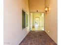 Elegant entryway with tiled flooring and a view through to the living areas at 16513 W Windsor Ave, Goodyear, AZ 85395