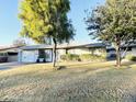 Ranch-style home with a large yard, featuring mature trees and a well-maintained lawn at 4936 E Coronado Rd, Phoenix, AZ 85008