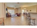 Spacious living room with tile floors, a fireplace, and access to the kitchen at 846 N Pueblo Dr # 111, Casa Grande, AZ 85122