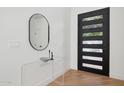 Modern entryway with black door and contemporary decor at 8133 E Cortez Dr, Scottsdale, AZ 85260