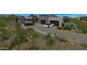 Modern home with a spacious driveway and desert landscaping at 10023 E Filaree Ln, Scottsdale, AZ 85262