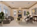 Bright living room with fireplace and large windows at 2717 W Nighthawk Way, Phoenix, AZ 85045