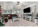 Spacious living room with L-shaped sofa and large TV at 3433 W Poinsettia Dr, Phoenix, AZ 85029