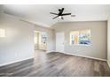 Bright living room featuring gray vinyl plank flooring and ceiling fan at 550 W Ramos Dr, Casa Grande, AZ 85122