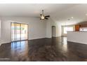 Open living room with sliding glass doors to backyard, high ceilings and stained concrete floors at 34831 N Mashona Trl, San Tan Valley, AZ 85143