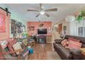 Living room with a brown leather couch, wood floors and ceiling fan at 2650 W Union Hills Dr # 184, Phoenix, AZ 85027