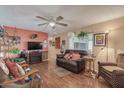 Cozy living room featuring a brown leather couch and wood flooring at 2650 W Union Hills Dr # 184, Phoenix, AZ 85027