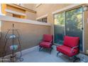 Cozy patio with two red chairs, perfect for relaxing at 15240 N 142Nd Ave # 1056, Surprise, AZ 85379