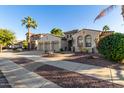 Three-car garage home with desert landscaping at 915 W Orchard Ln, Litchfield Park, AZ 85340