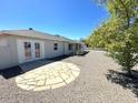 Back exterior of house showcasing a patio and gravel yard at 1719 E Verde Ln, Phoenix, AZ 85016