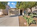 Tan two story house with two car garage and desert landscaping at 33970 N Cobble Stone Dr, San Tan Valley, AZ 85143