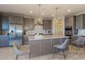 Modern kitchen with stainless steel appliances and large island at 18246 W Cielo Grande Ave, Surprise, AZ 85387