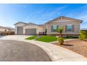 Modern home exterior with a three-car garage and artificial turf at 5170 N 186Th Dr, Litchfield Park, AZ 85340
