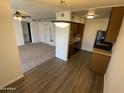 Kitchen features wood cabinets and laminate flooring at 3500 N Hayden Rd # 1903, Scottsdale, AZ 85251