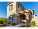 Two-story house with gray siding, stone accents, and a landscaped front yard at 2772 S Betty St, Gilbert, AZ 85295